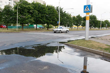 A car is driving through a pedestrian crossingの写真素材