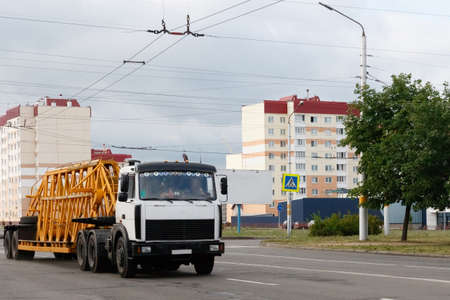 lorry with a semi-trailer rides on the road in the cityの写真素材