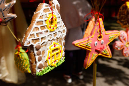 In the foreground a gingerbread in the form of a house, in the background a gingerbread in the form...