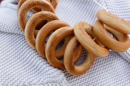 A bunch of bagels on a white fabric backgroundの写真素材