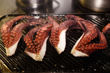 The tentacles of an octopus are grilled. Close-up viewの写真素材