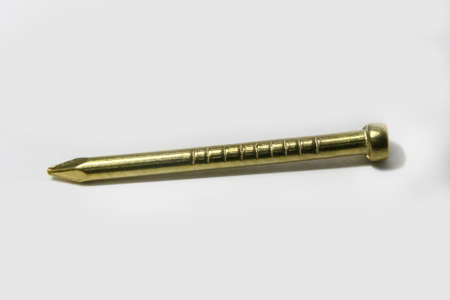 golden nail on a white background. close-upの写真素材