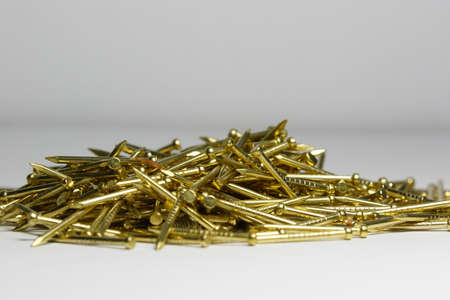 golden nails on a white background. close-upの写真素材