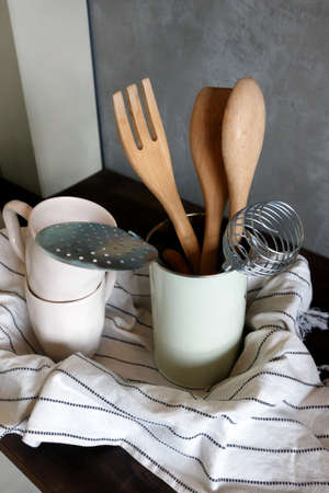 Side view of wooden and metal accessories standing on a table.