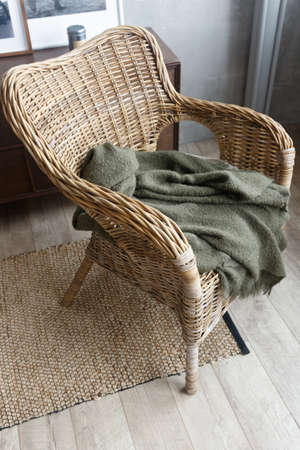 Wicker chair and plaid. View from above. The chair is on a wicker pathの写真素材