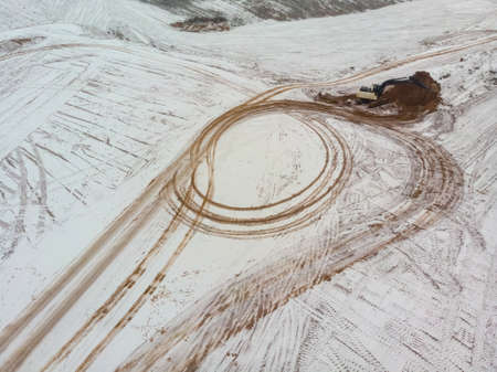 Excavator digs the ground. View from above. Aerial photographyの写真素材