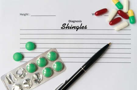 Shingles diagnosis written on a white piece of paper. Medical conceptの写真素材