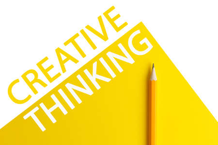 An interactive photo composition of an orange pencil and space for creative thinking (text) is used for presentation in the field of education, business or creativity. Lighting on a pencil in the studio. Yellow white backgroundの写真素材