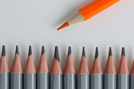 Support Group, Intervention. Conceptual. Orange and gray pencils opposite each other