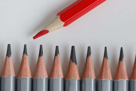 Support Group, Intervention. Conceptual. Red and gray pencils opposite each other on an isolated background. Shallow depth of fieldの写真素材
