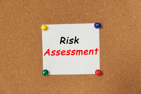 Text Risk Assessment written on a sticker pinned on a cork boardの写真素材