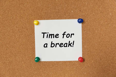 Text Time for a break written on a sticker pinned on a cork boardの写真素材