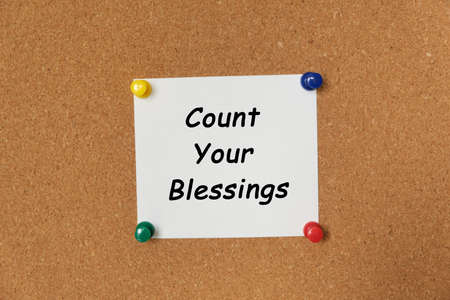 Text Count Your Blessings written on a sticker pinned on a cork boardの写真素材
