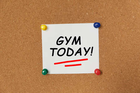 Text GYM TODAY written on a sticker pinned on a cork boardの写真素材