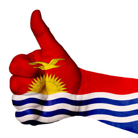 Hand making thumbs up sign, kiribati painted with flag as symbol of thumbs up, like, okay, positive - isolated on white backgroundの写真素材
