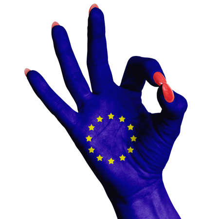 The national flag of the European Union is painted on a female hand showing the OK sign. Image on a white backgroundの写真素材