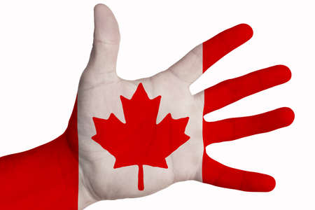 A man showing the flag of Canada in the palm of his hand. Image on a white backgroundの写真素材