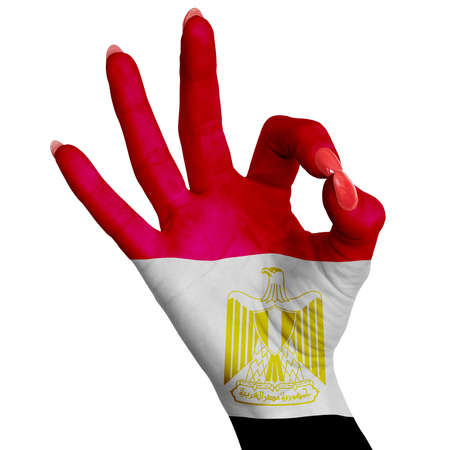 The Egyptian national flag is drawn on a female hand showing the OK sign. Image on a white backgroundの写真素材