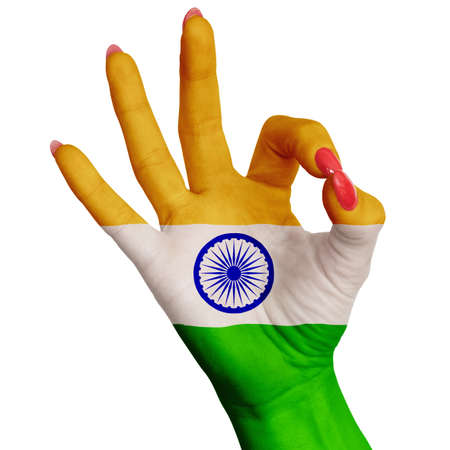 The national flag of India is painted on a female hand showing the sign OK. Image on a white backgroundの写真素材