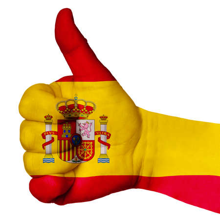 Hand with thumb up, Spain flag painted as symbol of excellence, achievement, good - isolated on white backgroundの写真素材