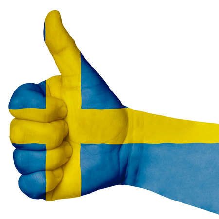 Hand with thumb up gesture in colored sweden national flag as symbol of excellence, achievement, good, - useful for tourism and touristic advertisingの写真素材