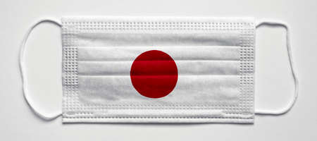 Japan flag. PANDEMIA. Medical mask, Medical protective mask on a white background.Healthcare and medical concept.の写真素材