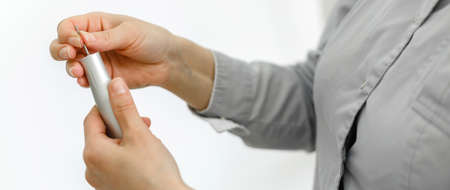 Treatment of toenails, pedicure. Hands in gloves with a pedicure tool. Close-upの写真素材