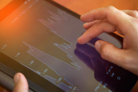 Business, office - man with tablet pc and chart works. Financial conceptの写真素材