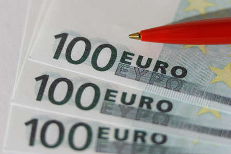 Euro close-up. Macro of money. Cash banknotes are stacked. Ballpoint pen. European currencyの写真素材