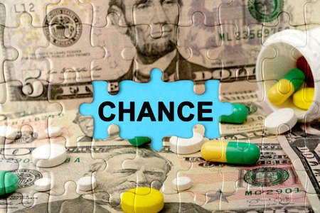 Double exposure. Puzzles depicting pills and dollars with the inscription - CHANCE. The concept of medicine.の写真素材