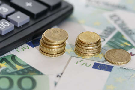 Euro banknotes with a calculator and coins. Close-up. Business conceptの写真素材