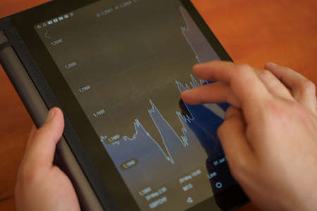 Business, office - man with tablet pc and chart works. Financial conceptの写真素材