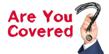 Hand with marker writing: Are You Covered. Hand of a businessman with a marker.の写真素材