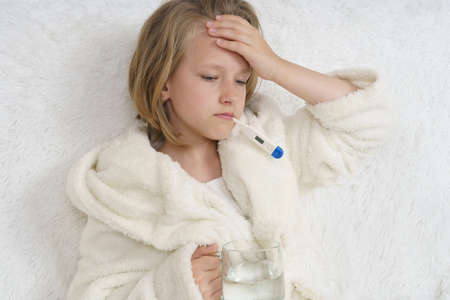 A sick teenage girl clings to her head. Medical concept.の写真素材