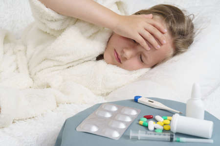 A sick teenage girl clings to her head. Medical concept.の写真素材