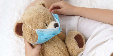A sick teenage girl measures the temperature, next to her is a cat. Medical concept.の写真素材
