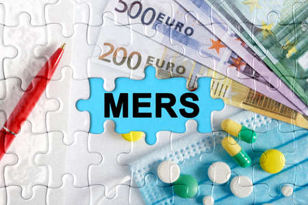 Double exposure. Puzzles with the image of pills, medical mask, pens and euro with the inscription -. The concept of medicine.の写真素材