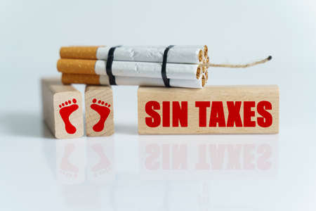 The concept of medicine is the fight against smoking. Cigarettes were twisted into a dynamite checker, and the wick was on wooden dies on which it was written - SIN TAXESの写真素材