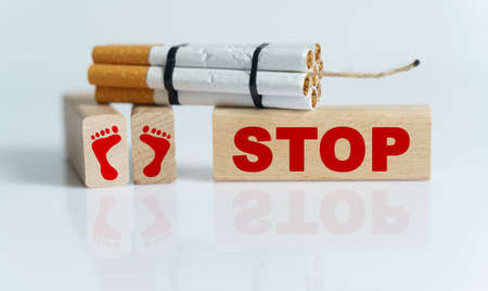 The concept of medicine is the fight against smoking. Cigarettes were twisted into a dynamite checker, and the wick was on wooden dies on which it was written - stopの写真素材