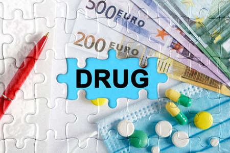 Double exposure. Puzzles with the image of pills, medical mask, pens and euro with the inscription -DRUG. The concept of medicine.の写真素材
