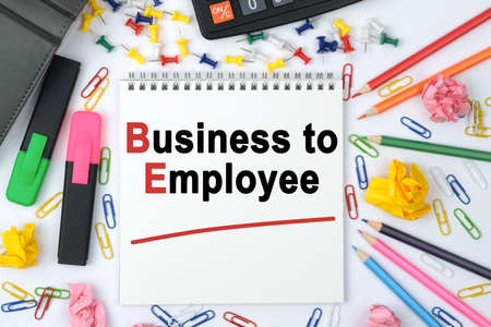 Business concept. On the table is a calculator, diary, markers, pencils and a notebook with the inscription - Business to Employeeの写真素材
