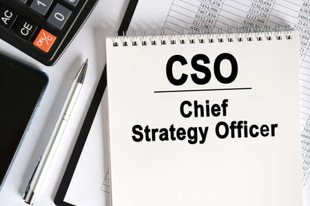 On the table lies a smartphone, a calculator and a notebook with the inscription- CSO. Chief Strategy Officer. Business conceptの写真素材