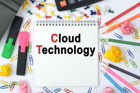 Business concept. On the table is a calculator, diary, markers, pencils and a notebook with the inscription - Cloud Technologyの写真素材