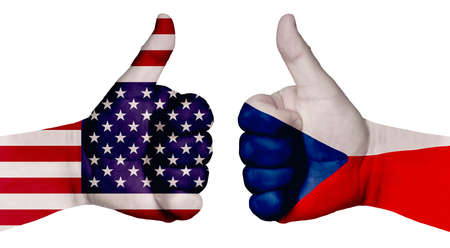 The concept of strengthening the relationship of nations. Two hands are painted with flags of different countries, with a thumb raised up. Czech Republic and the USAの写真素材