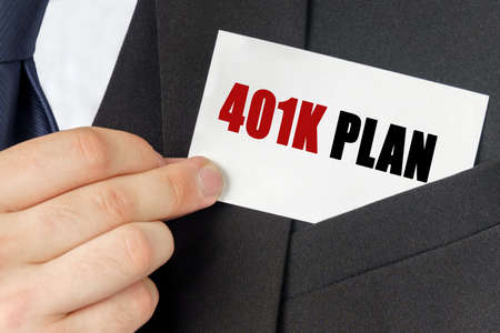 Business concept. Businessman holds a card with the text - 401K PLANの写真素材