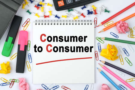 Business concept. On the table is a calculator, diary, markers, pencils and a notebook with the inscription - Consumer to Consumerの写真素材