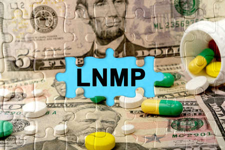 Double exposure. Puzzles depicting pills and dollars with the inscription -LNMP. The concept of medicine.の写真素材
