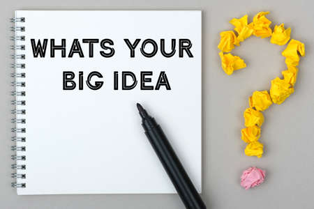 Hand with marker writing: Whats Your Big Idea. Notepad and question mark.の写真素材