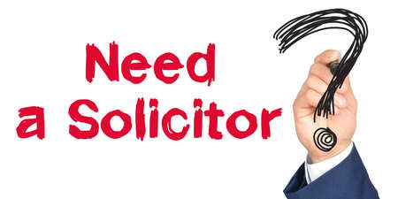 Hand with marker writing: Need a Solicitor. Hand of a businessman with a marker.の写真素材
