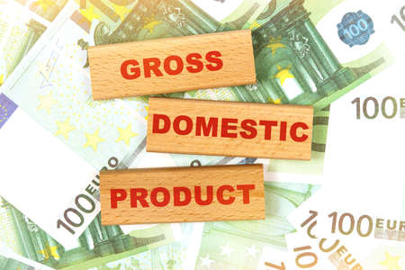 Business concept. Against the background of euro bills, the text is written on wooden blocks - gross domestic productの写真素材